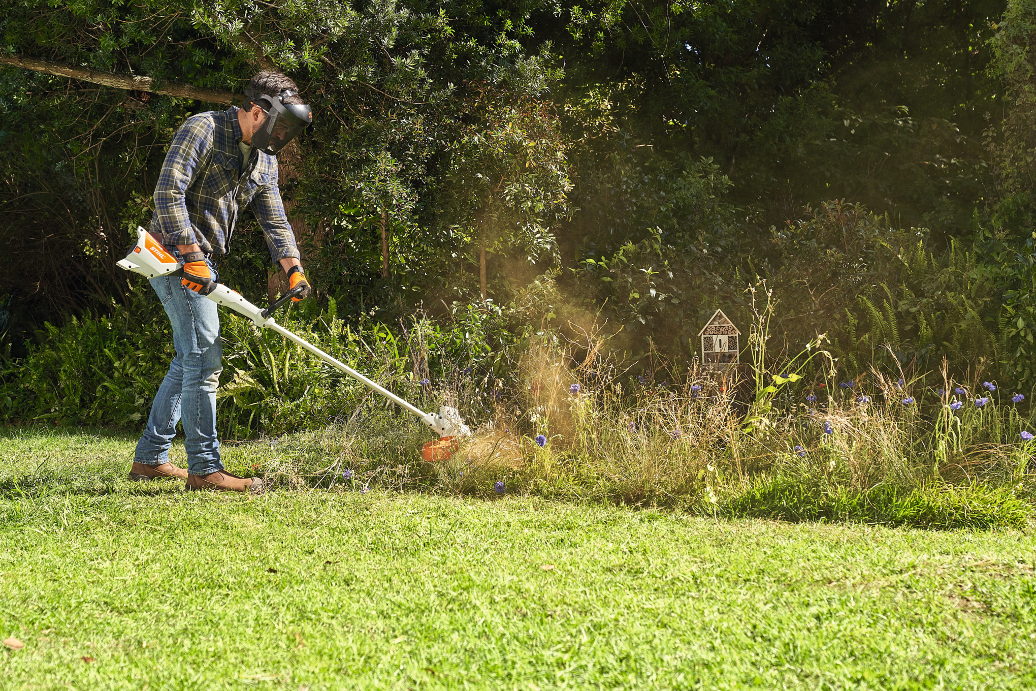 Man mowing flower meadow with FSA 57