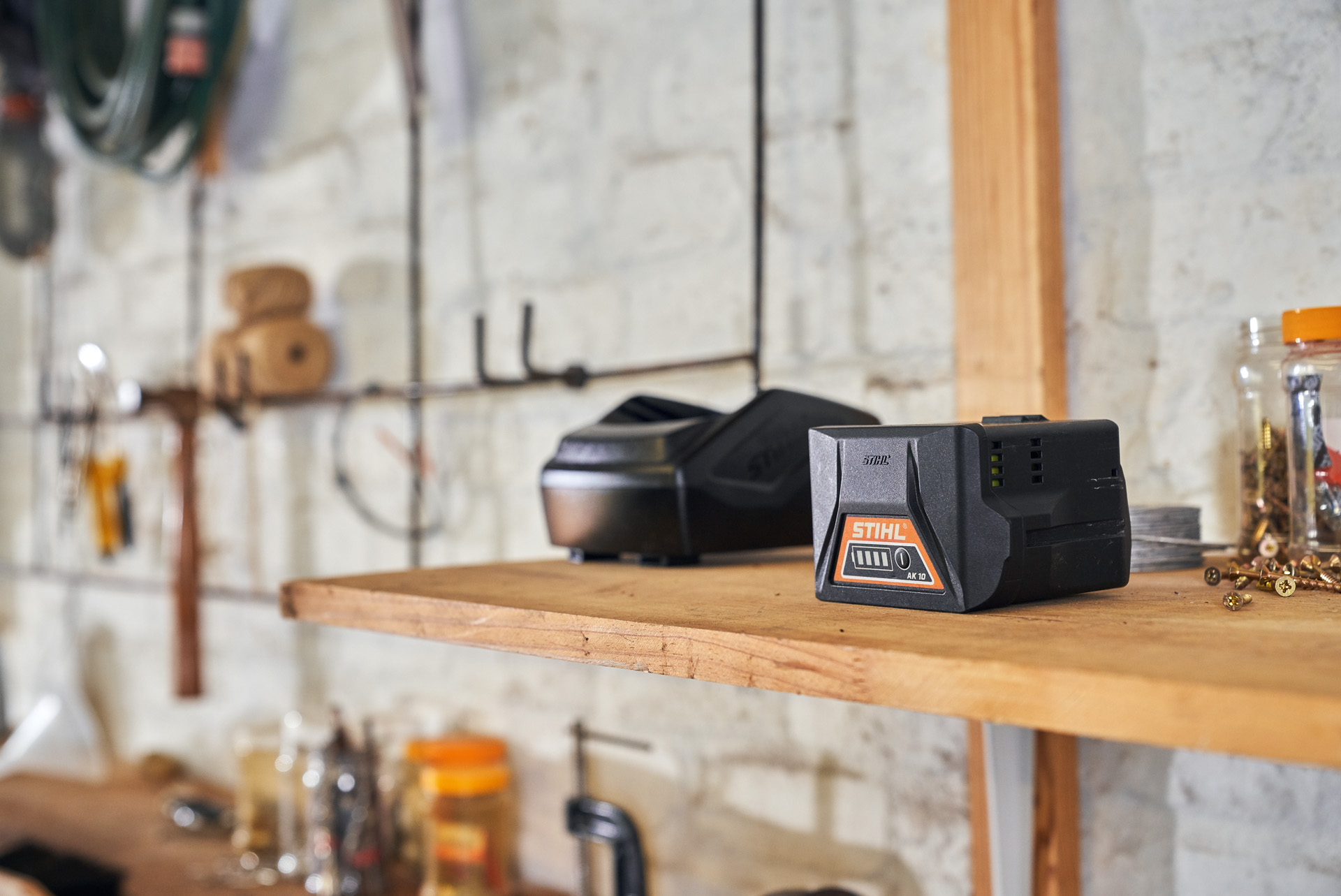 A lithium-ion battery and charger on a shelf