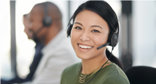 A woman with a headset smiling to camera